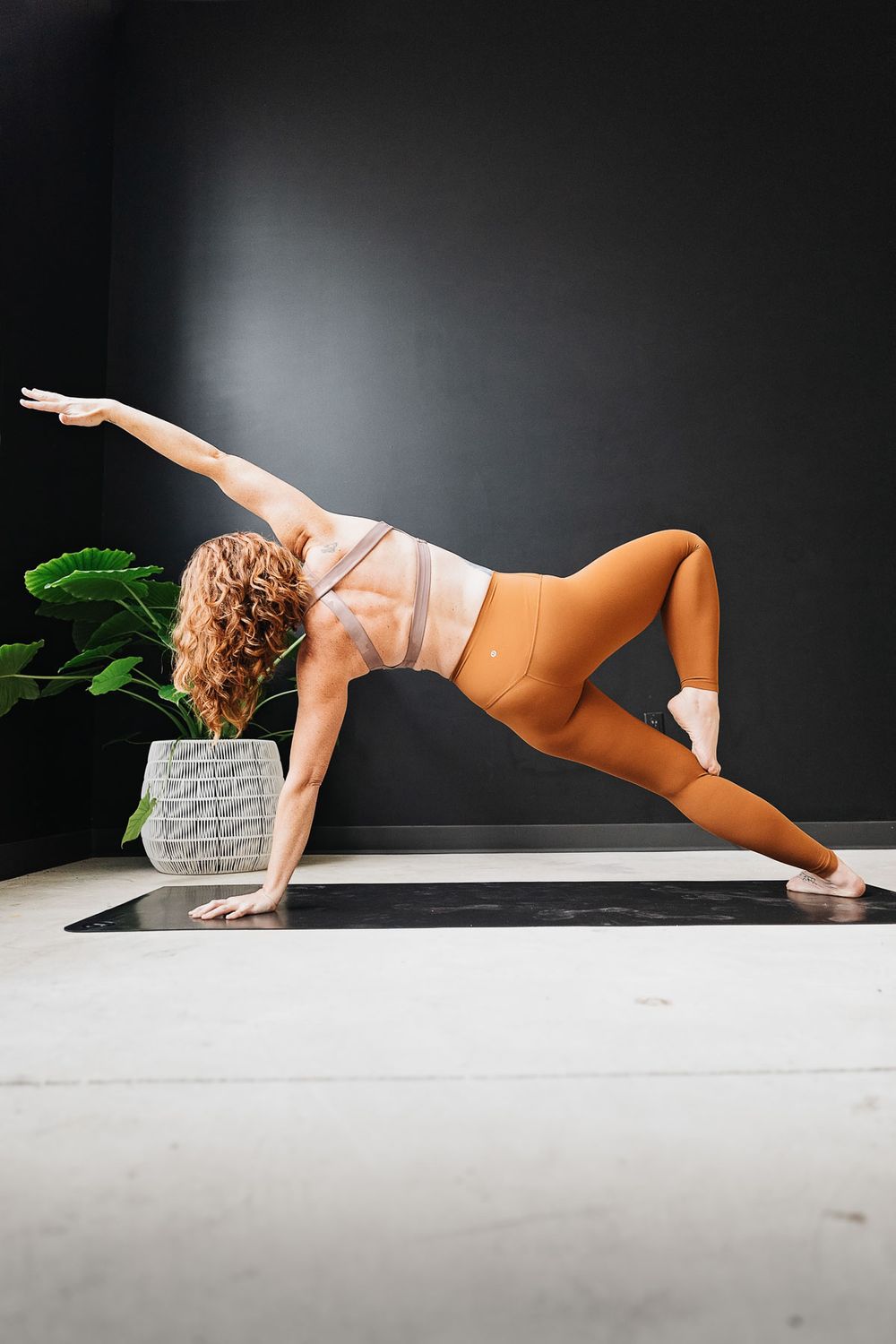 Core strength exercise sequence shown in orange activewear against dark background.