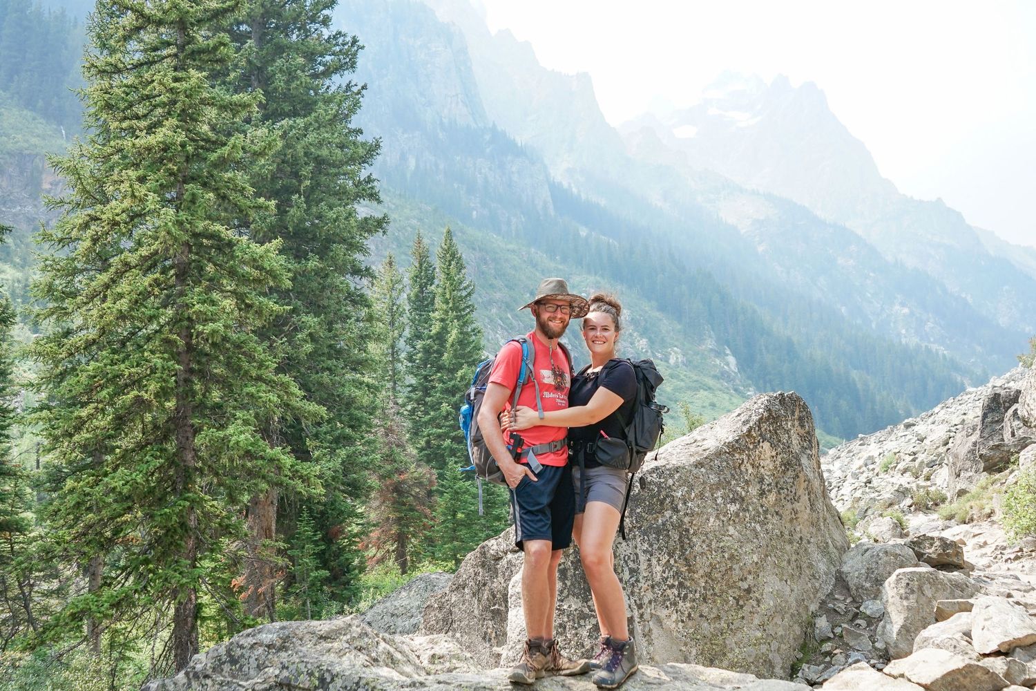 couple enjoying cascade canyon at grand teton national park mountains wyoming husband and wife married photoshoot