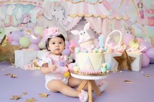 Enchanting unicorn party scene with soft pink tulle, rainbow balloons, and glittering decorative elements.
