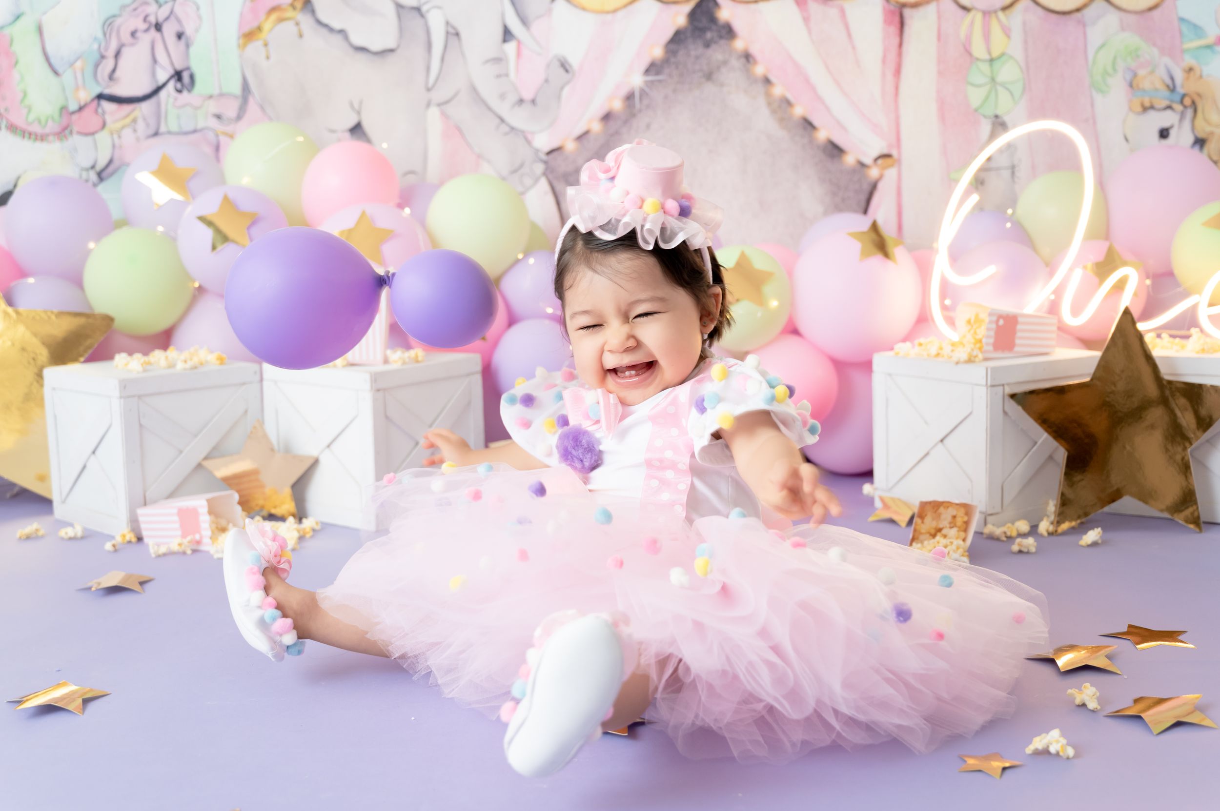 Magical first birthday celebration with unicorn decor, pastel balloons, and sparkly accents creating a fairytale atmosphere.