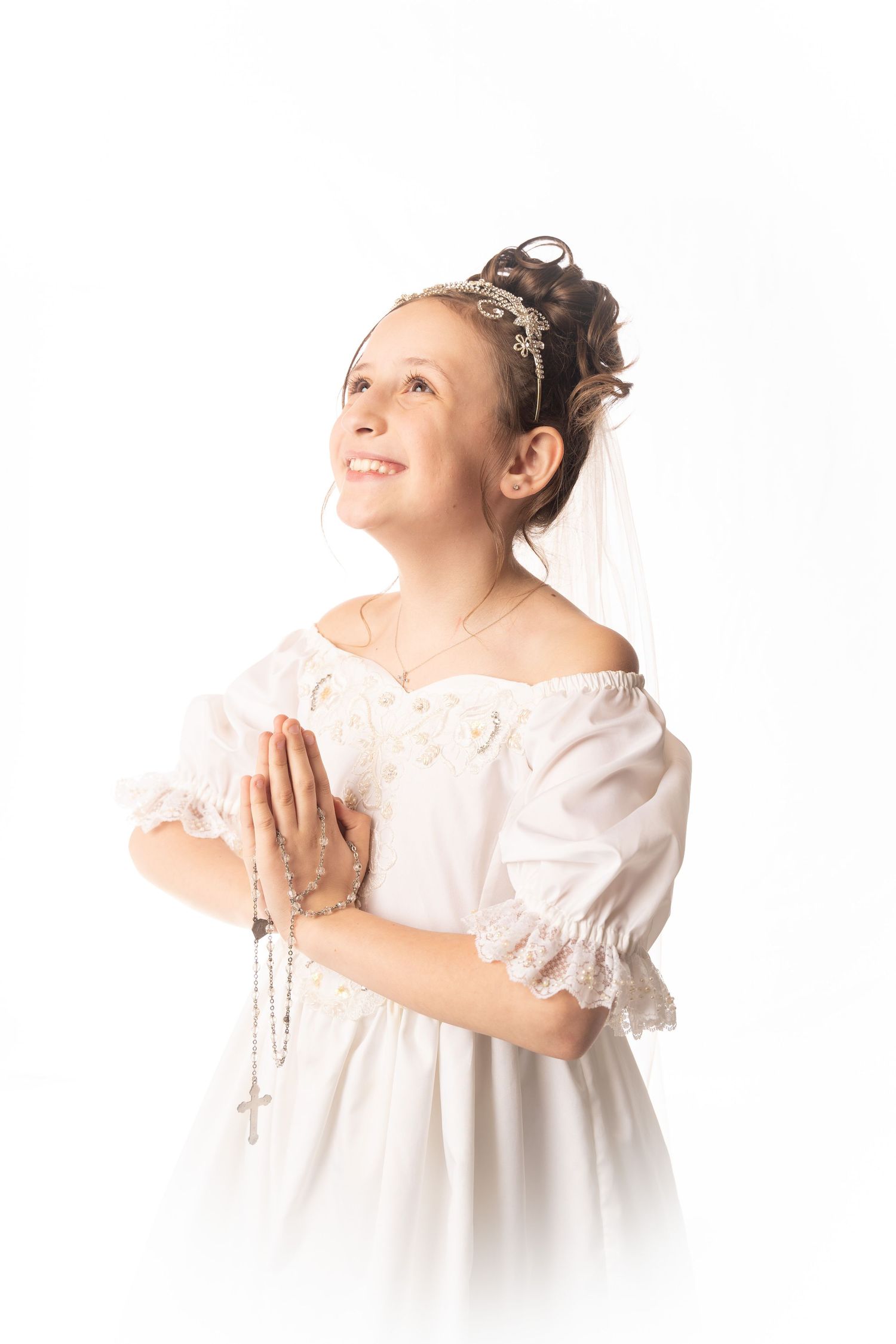 White communion dress series with delicate poses against bright background.