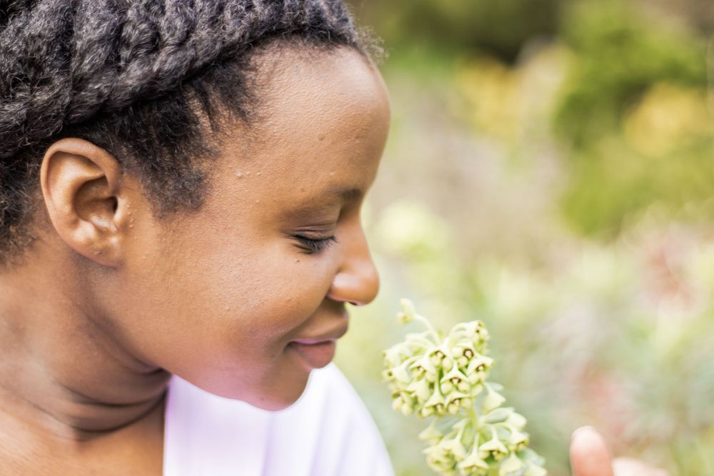 Close-up profile shot with delicate white flowers in soft focus.