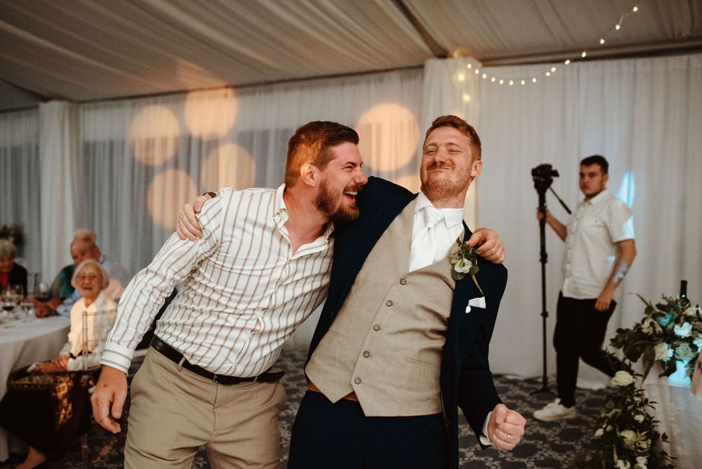 groom dancing with a friend