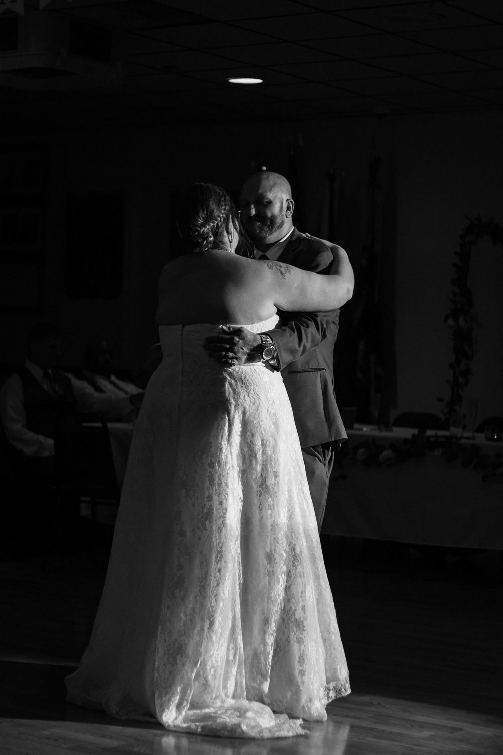 Black and white image of white lace wedding dresses in a dance studio.