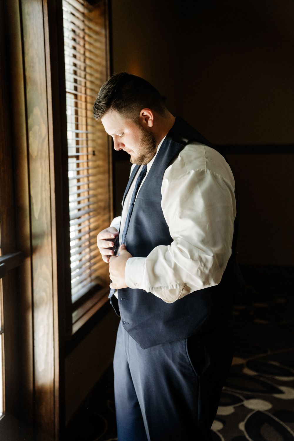 A sequence of getting ready moments captured through window light in a dark room.