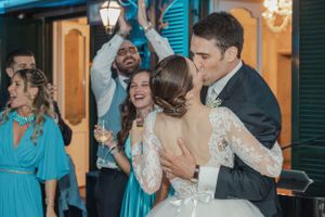 Newlyweds and guests dancing and celebrating at a vibrant wedding reception.