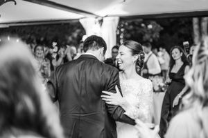 Black and white photos show guests dancing and celebrating at a wedding reception.