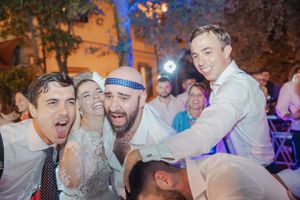 Wedding party celebration with guests dancing and enjoying lively reception festivities.