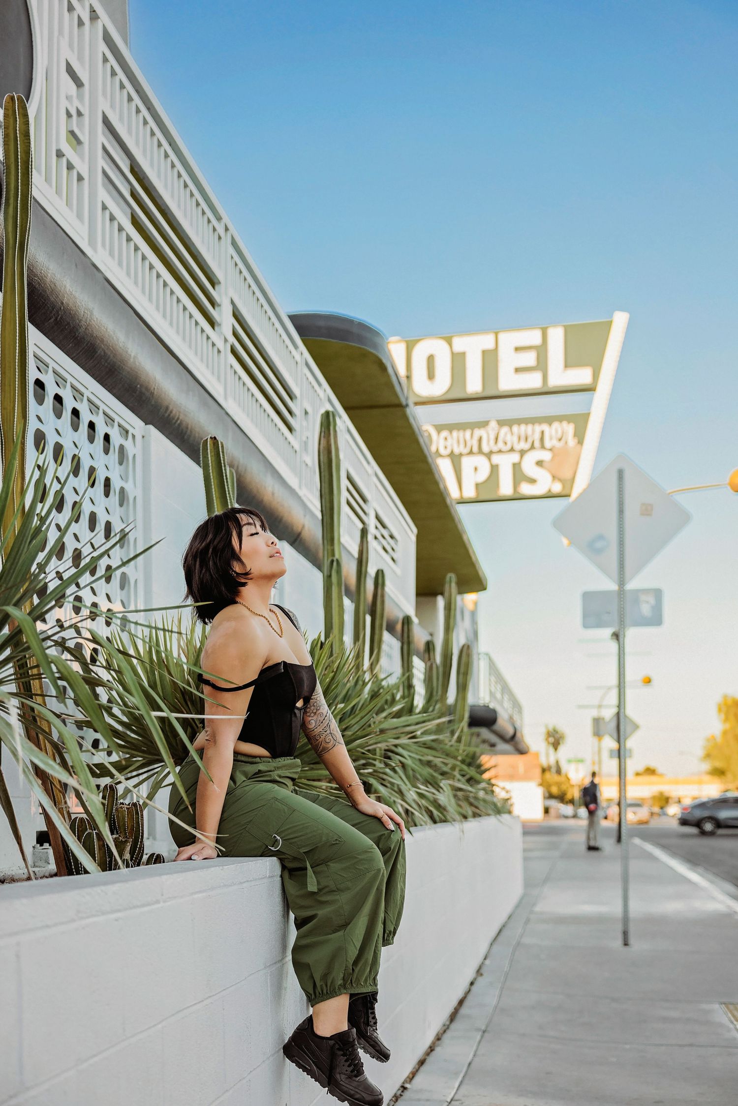 Urban scene with vintage motel sign and street view at golden hour.
