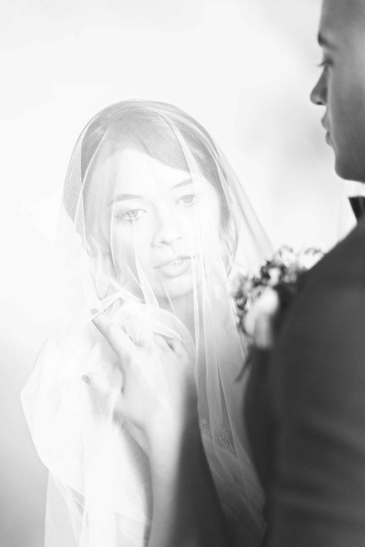 A ethereal series of bridal portraits shot through sheer white fabric creating a soft dreamy effect in black and white euridge manor