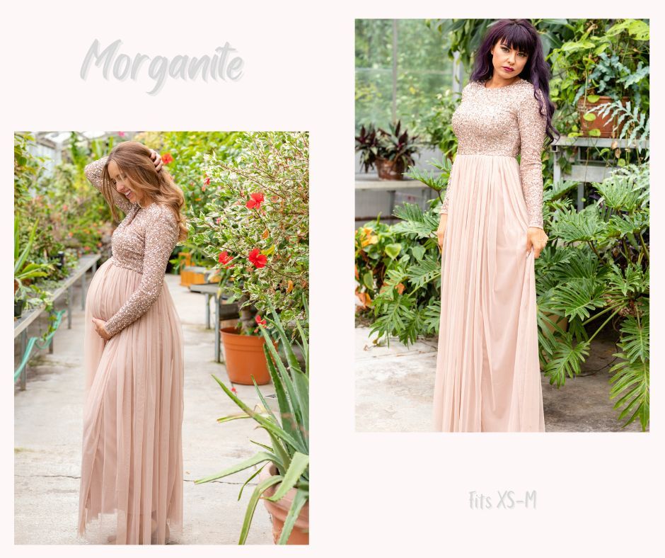 Blush pink maternity gown with delicate details photographed in garden with red flowers.