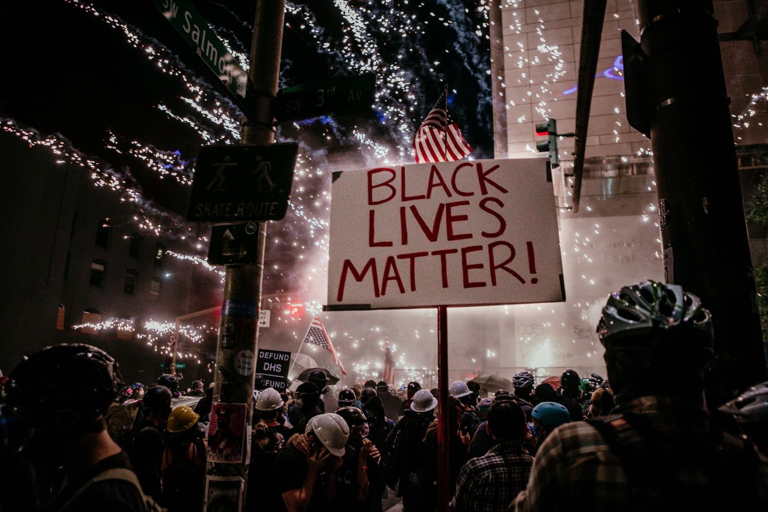 a firework explodes in crowd of people oustide federal courthouse BLM portland oregon photojournalist