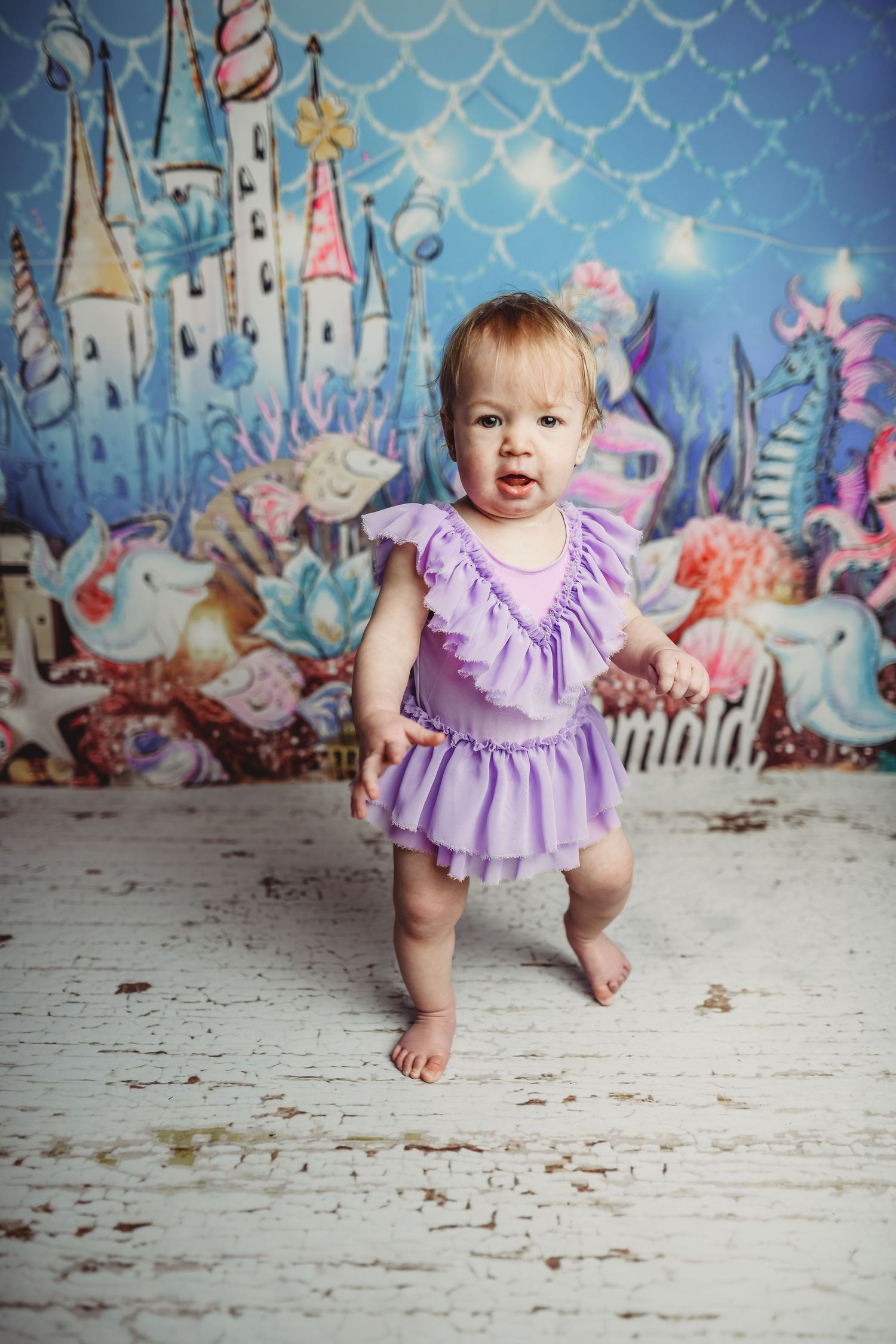Magical castle backdrop with purple and blue tones featuring whimsical fairy tale elements.