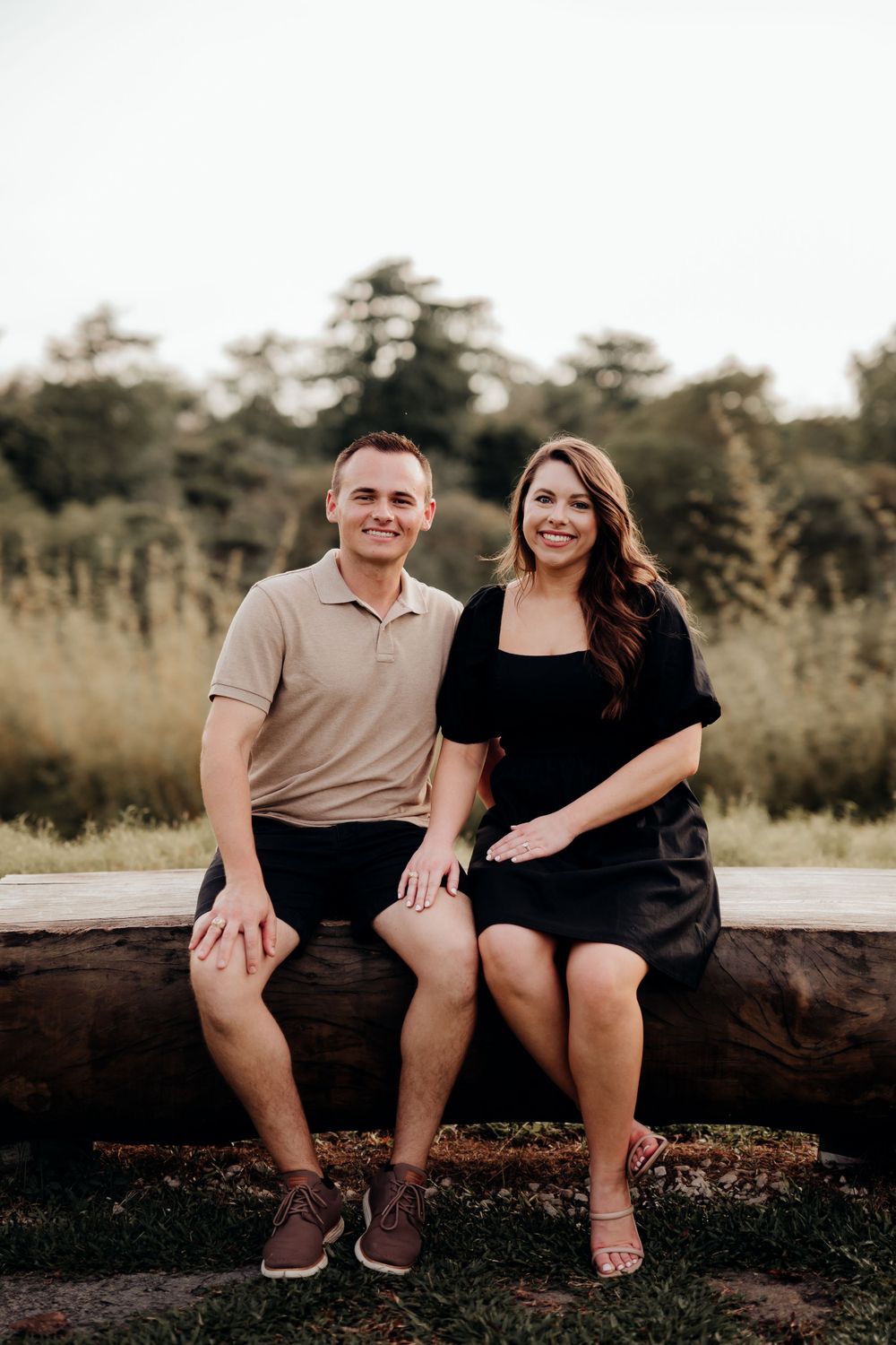 Couple posing for camera with a nice scenery at the back