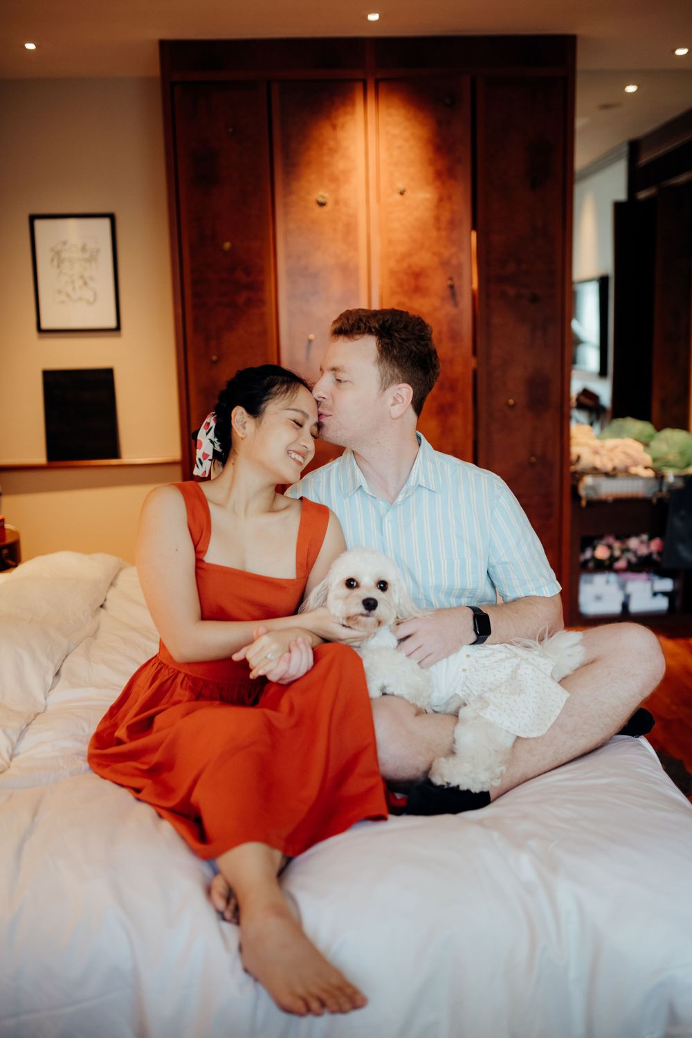 Hotel couple portrait inside the room with pet