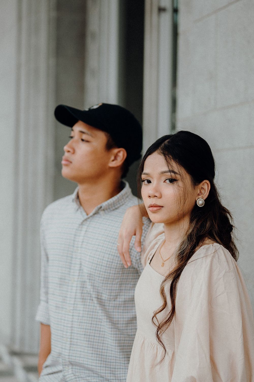 Lady in focus while partner is looking away during photoshoot