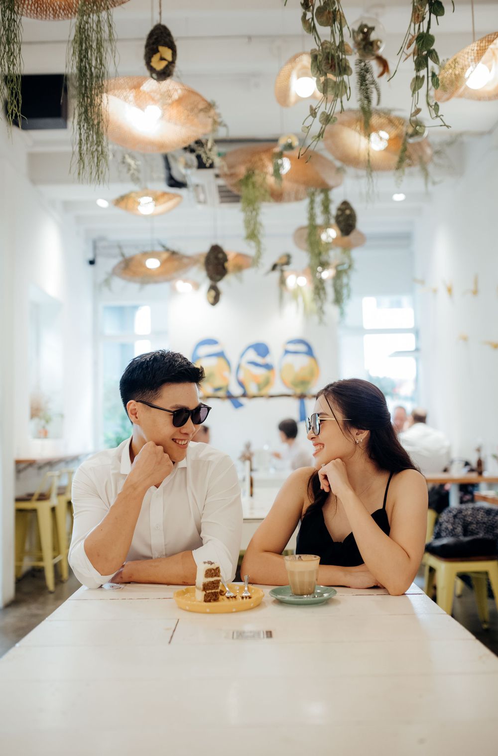 Couple photoshoot inside a cafe with sunglasses