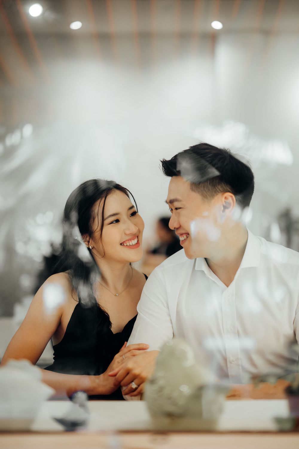 Couple looking at each other inside a cafe photoshoot