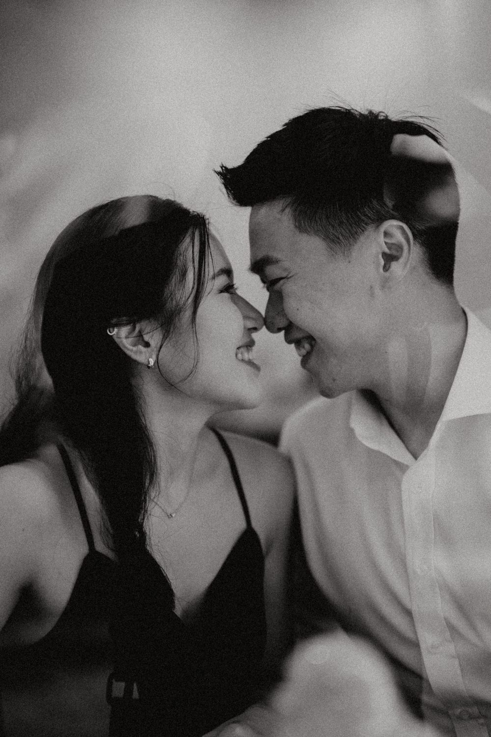 couple looking at each other inside a cafe in black & white
