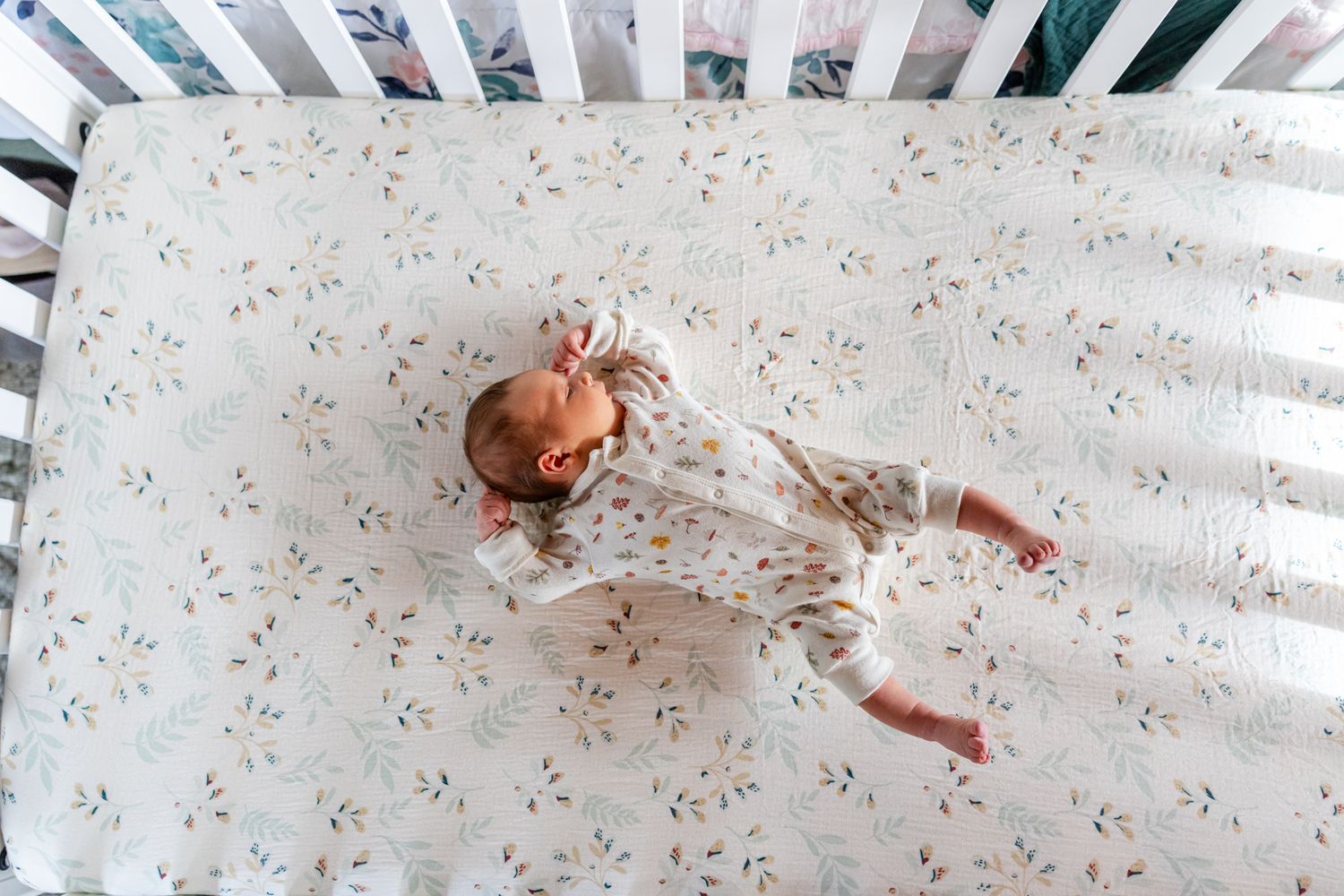 newborn girl in a white crib