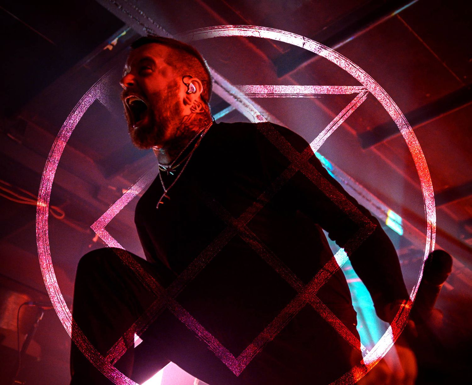 A concert performer silhouetted against a geometric red and blue light design.