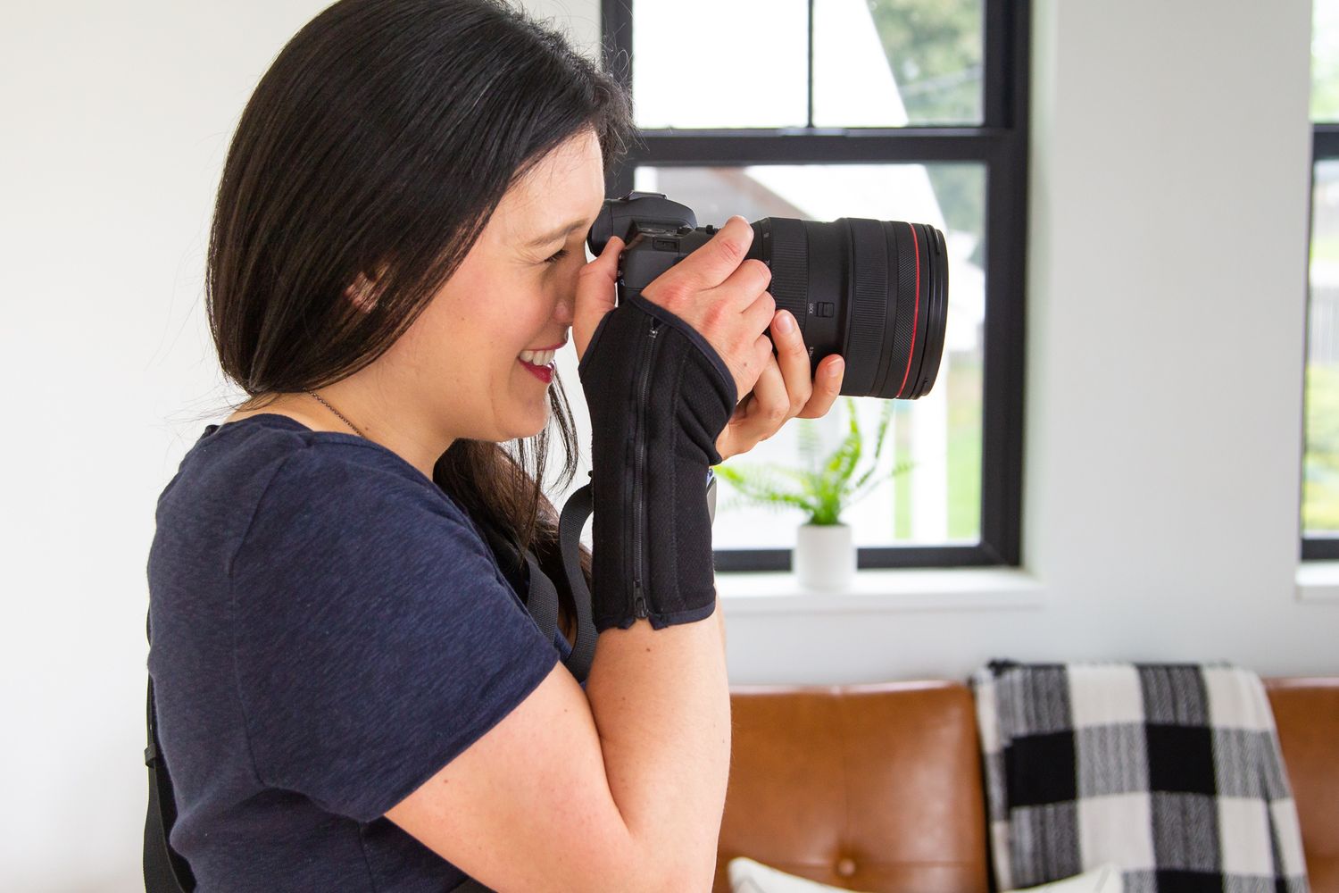 woman photographer taking photos, holding camera up to face in Issaquah, WA