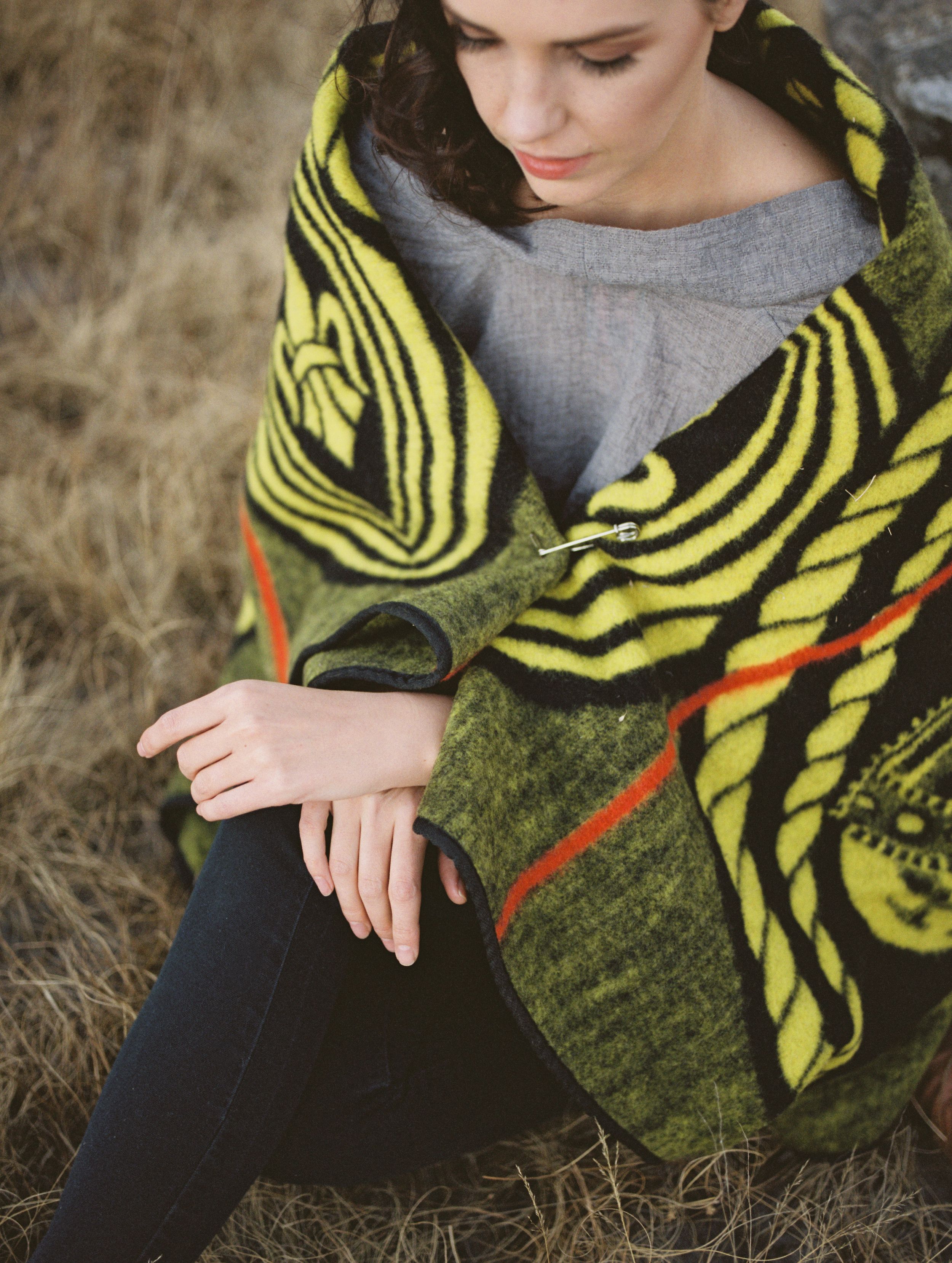 A woman wearing a traditional yellow Basotho blanket.