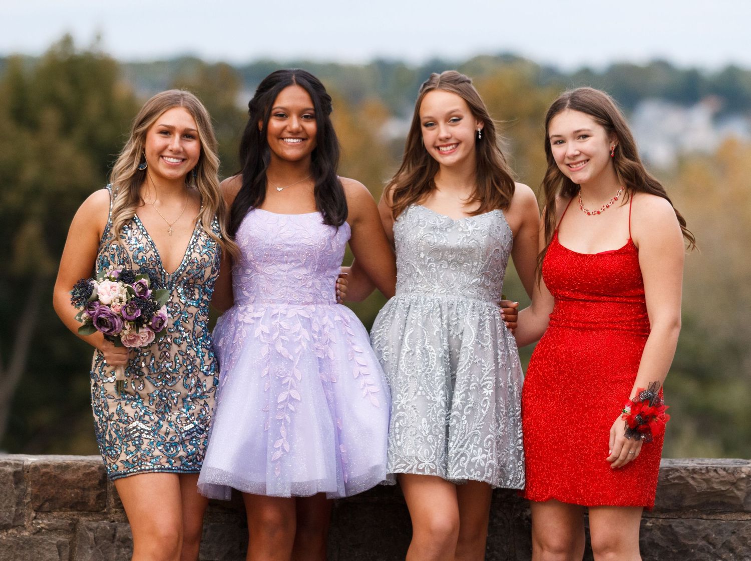 Four friends pose together in sparkly formal dresses at an outdoor event.youngstown photographer boardman photographer ohio photographer col