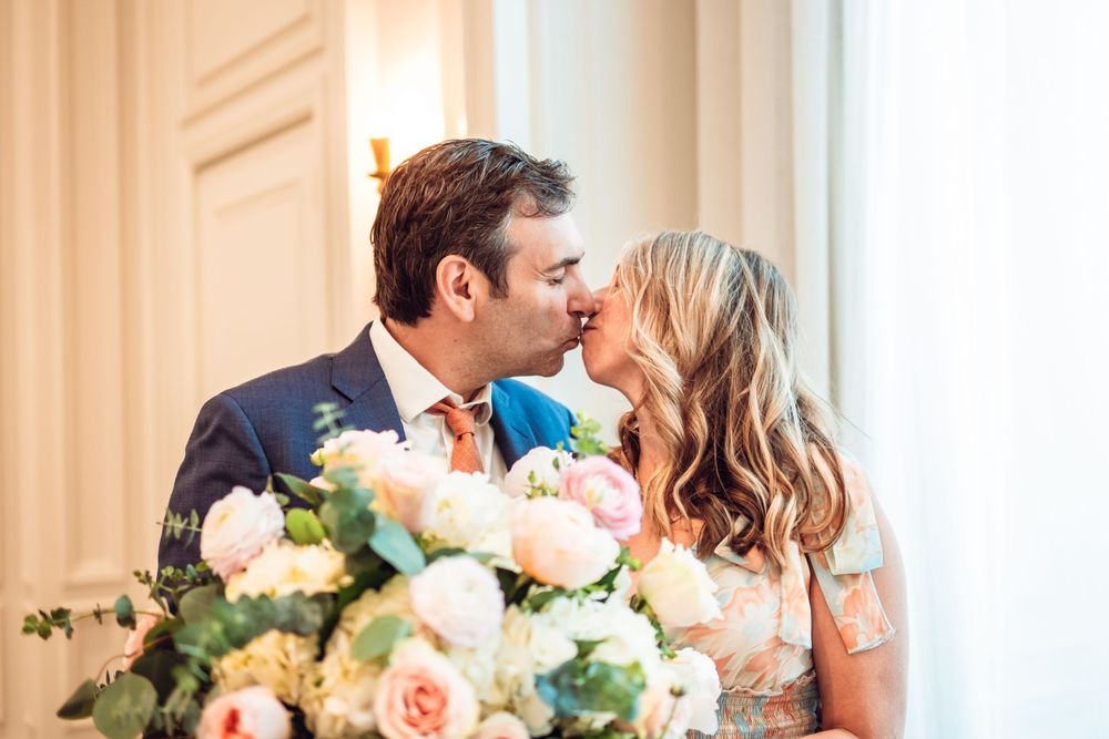 Elegant wedding reception venue with white walls, ornate mirrors, and hanging pendant lights.