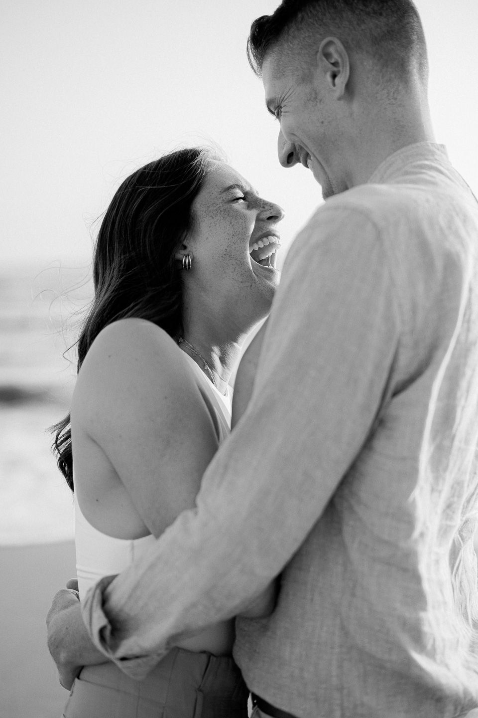 girl laughing in boyfriend hug
