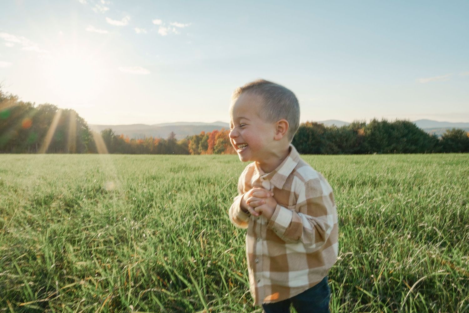 boy laughing in field