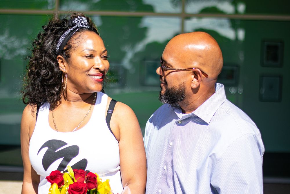 Couple sharing a happy moment outdoors with beautiful flowers.