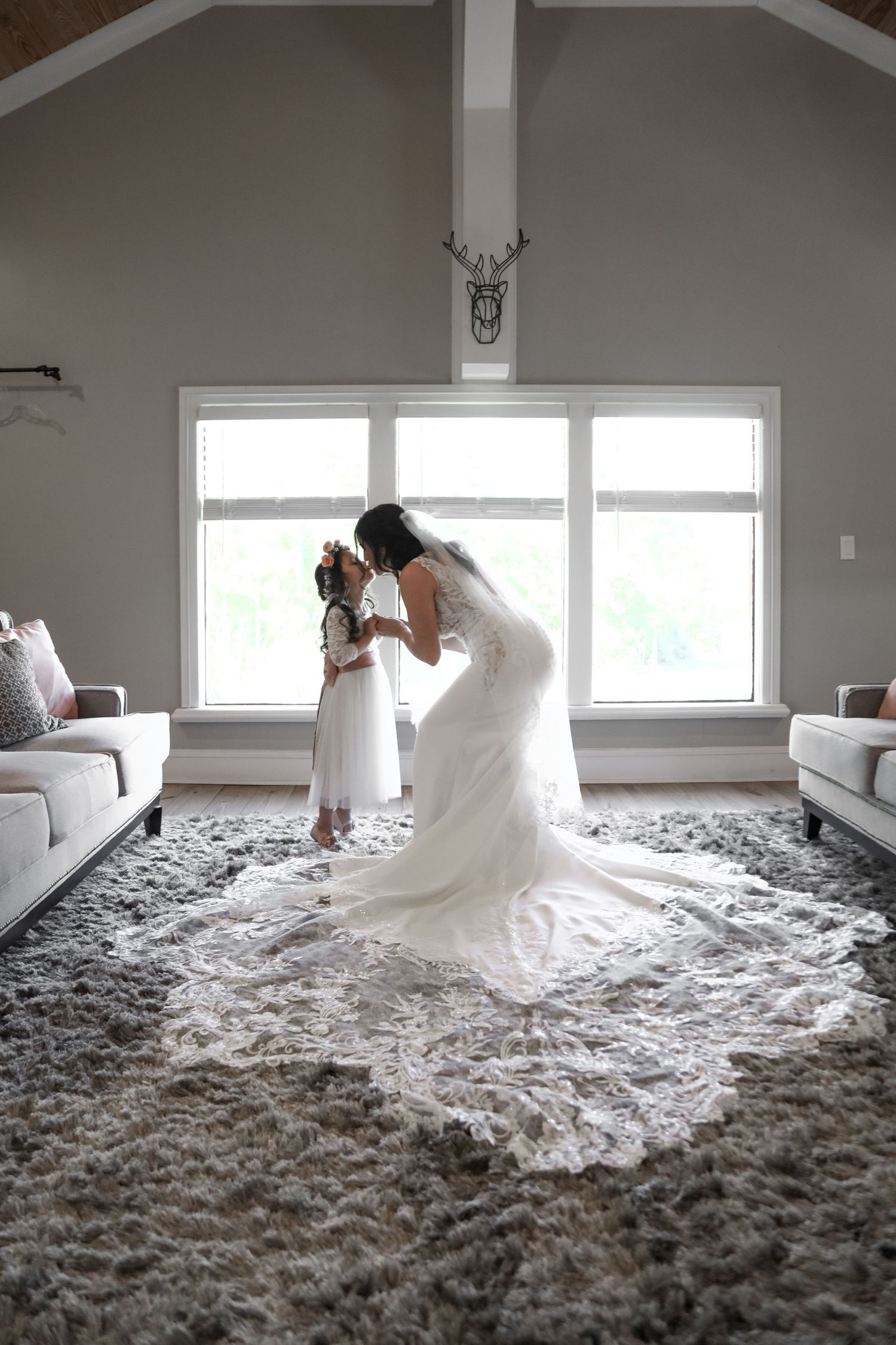 Elegant living room wedding moment with long train dress and modern decor.