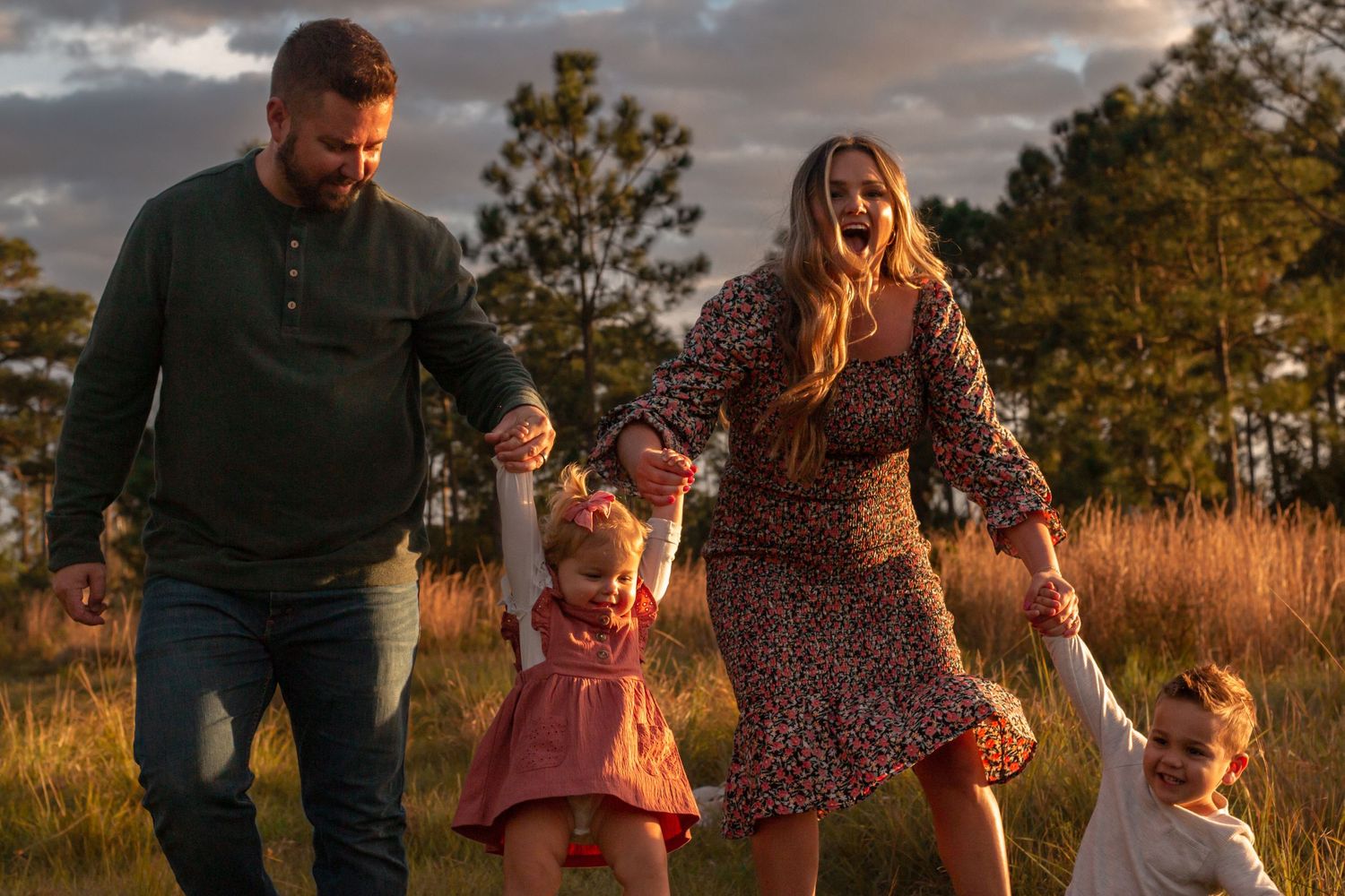 Family laughing together in a field in Stuart, Florida