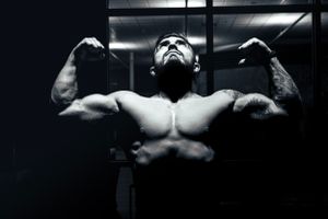 Athlete doing a double biceps pose in a cinematic photo