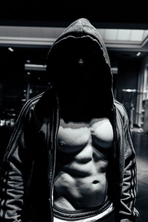 Athlete posing confidently with weights in background