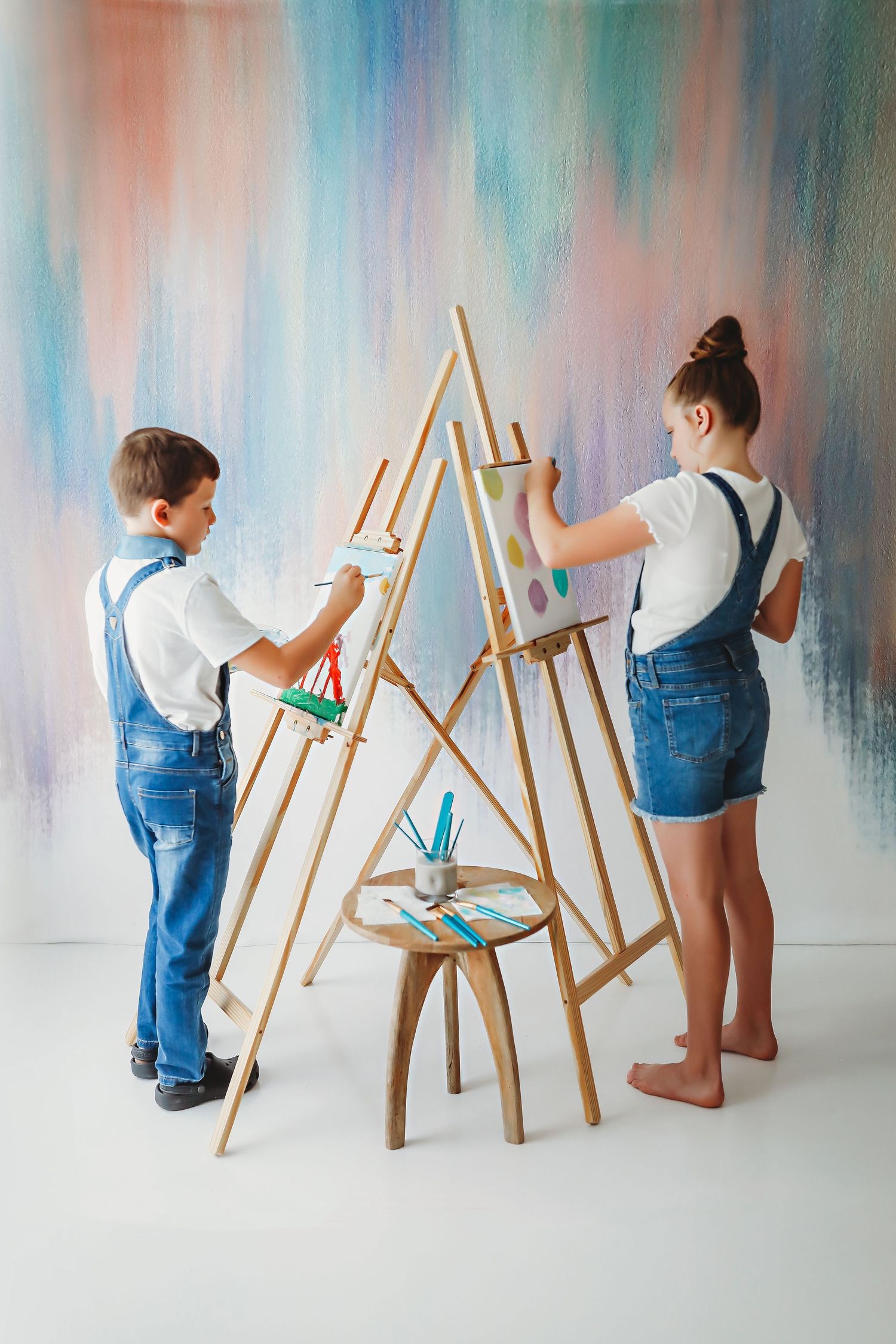 2 children painting at a photo session