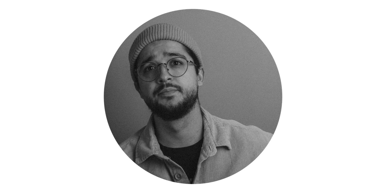 Artistic black and white portrait against a dark background.