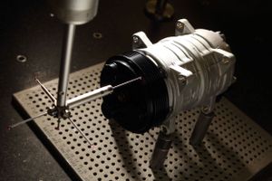 Close-up of mechanical part being repaired on industrial workbench.