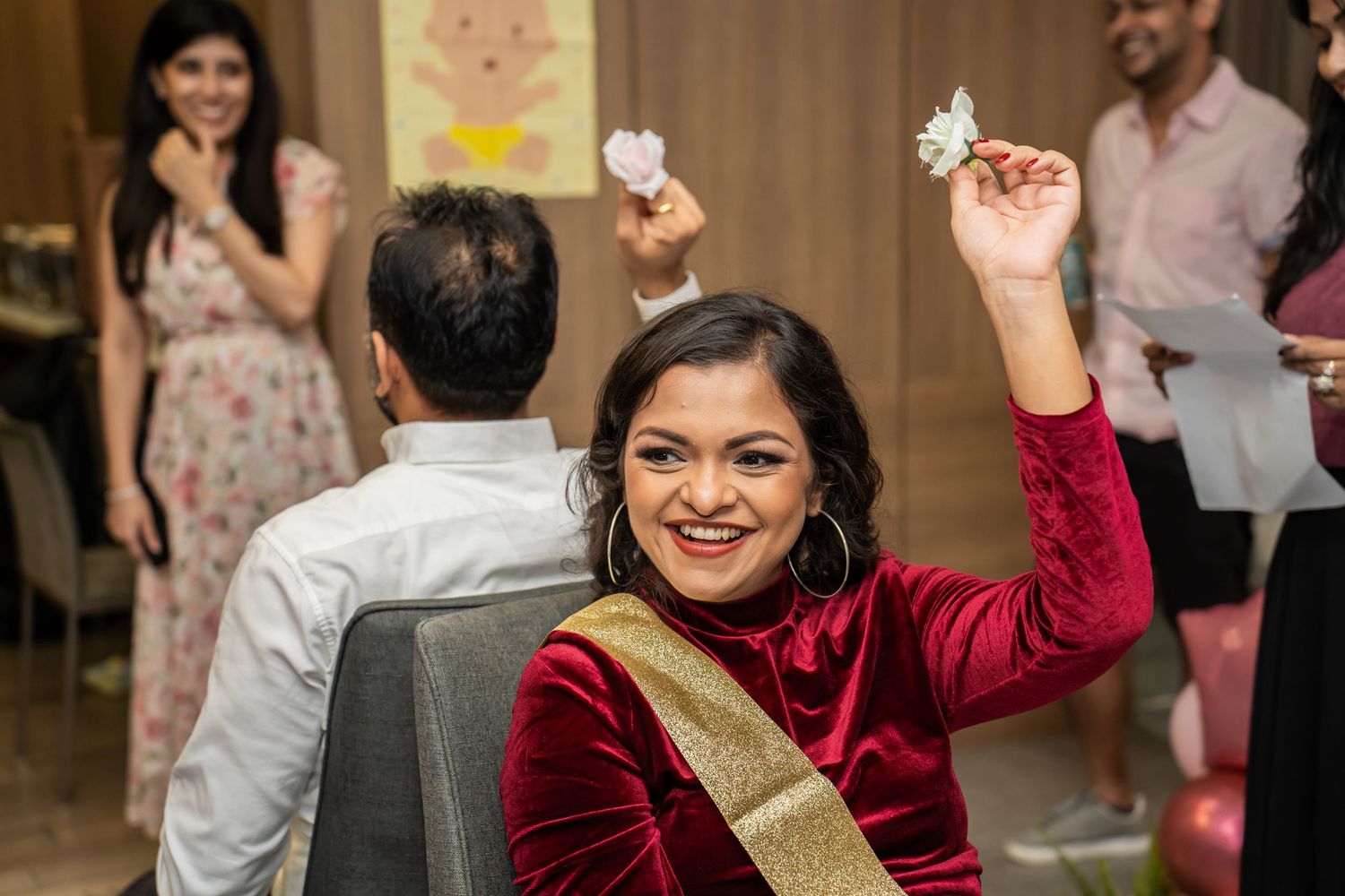 A joyful celebration moment in a decorated event space.