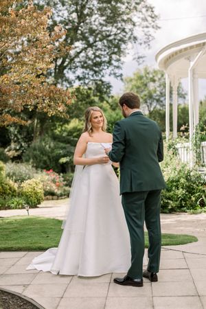 bride and groom first look and reading vows together at The Wildflower 301 Wedding Venue wedding in greensboro, georgia