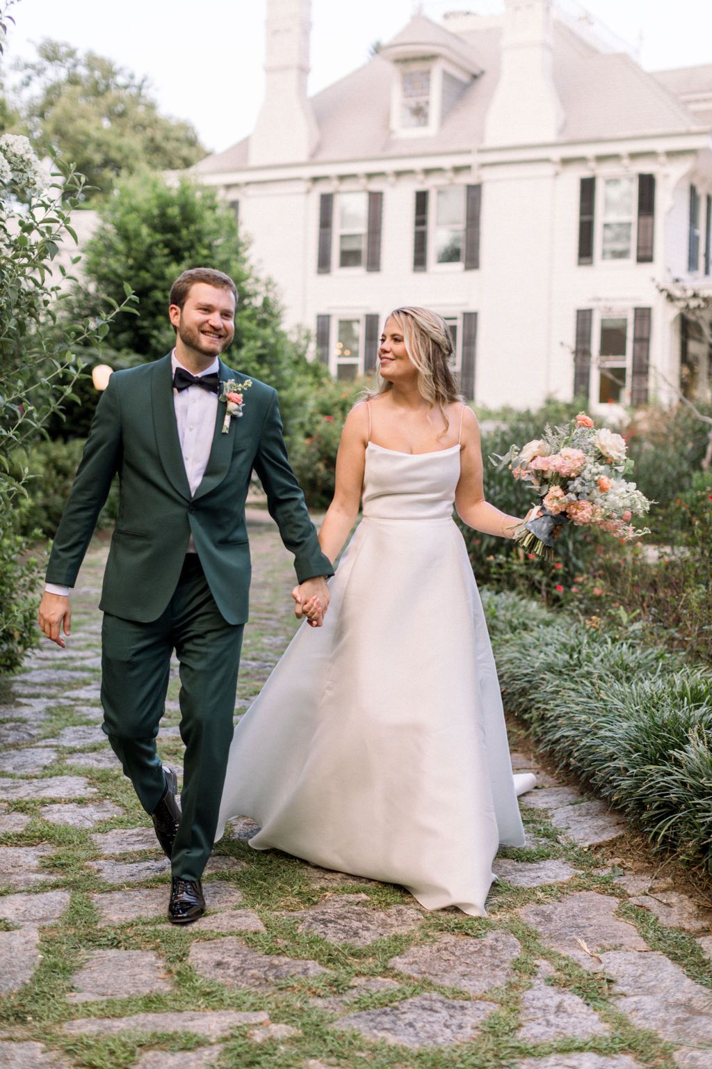 bride and groom walking at The Wildflower 301 Wedding Venue wedding in greensboro, georgia