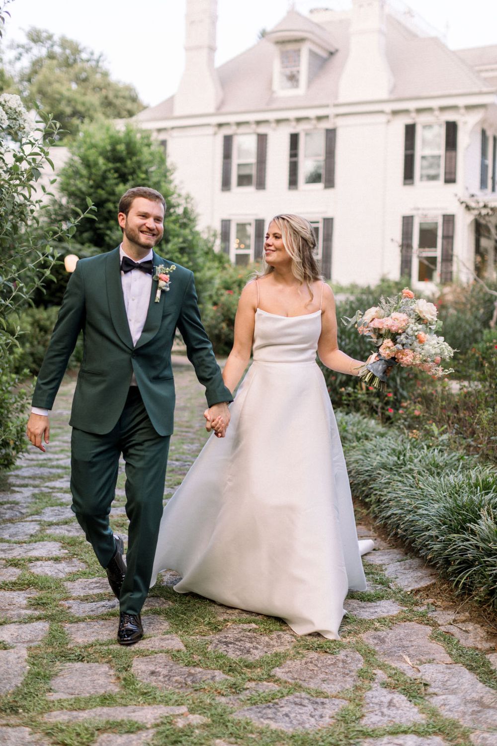 bride and groom walking at The Wildflower 301 Wedding Venue wedding in greensboro, georgia