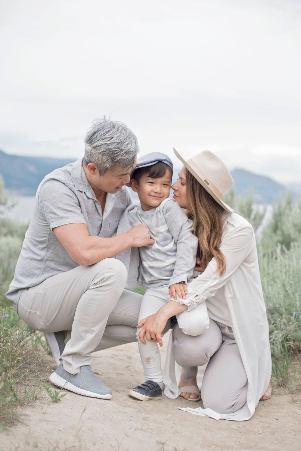 A tender family moment captured against a mountain landscape backdrop at Penticton, B.C.