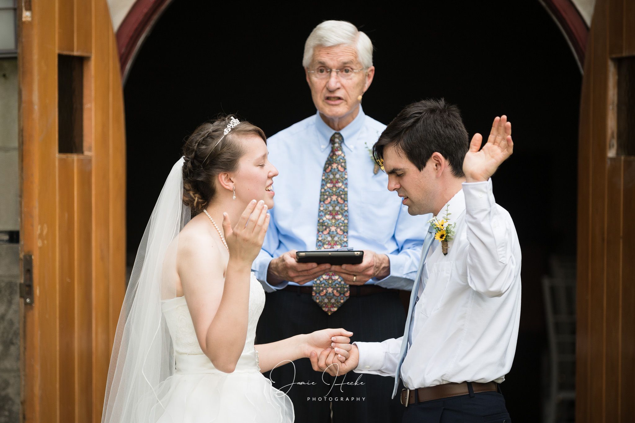 A lighthearted moment during the wedding ceremony as the couple exchanges rings.