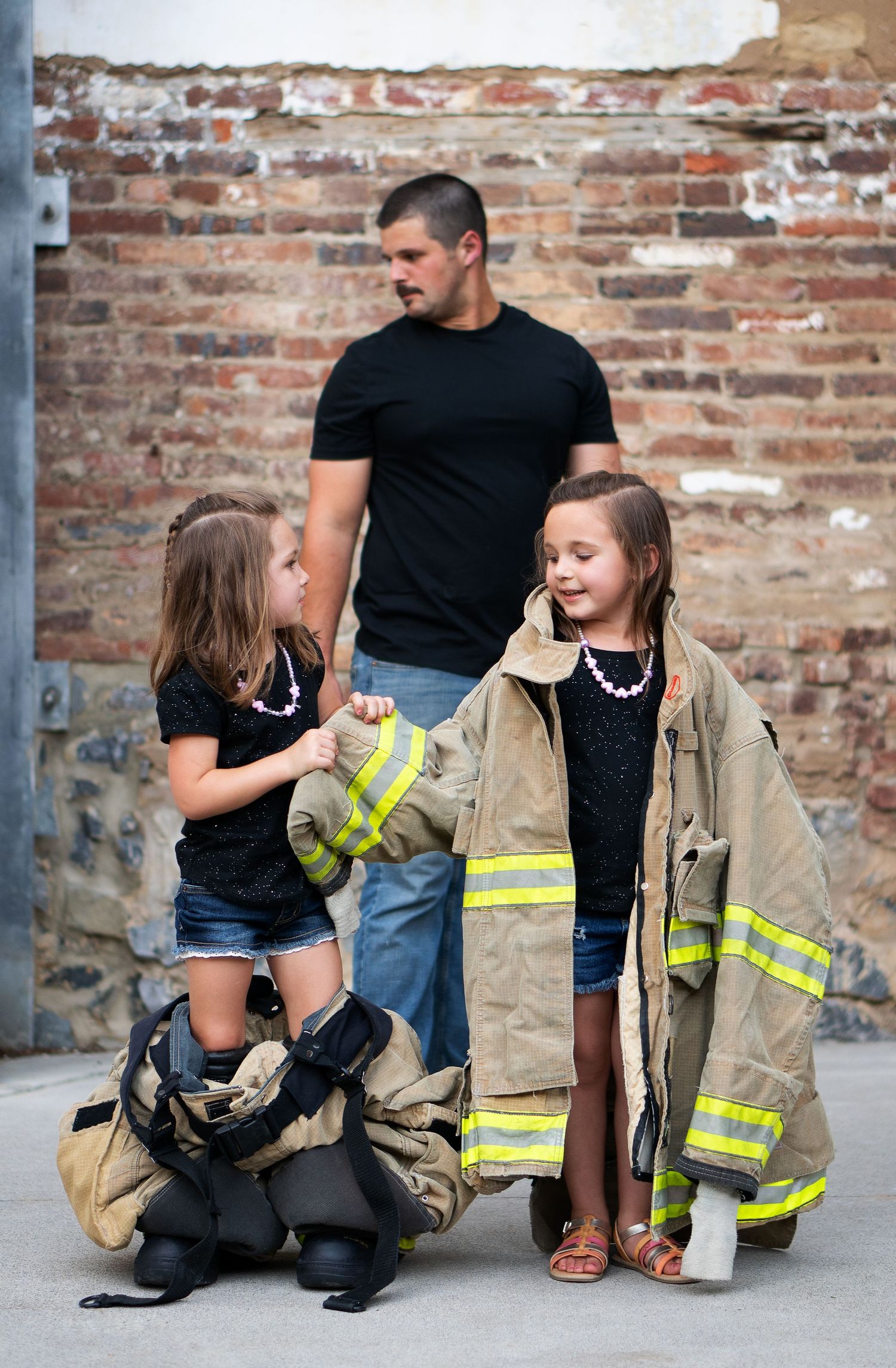 Fireman's daughters play dress up with gear