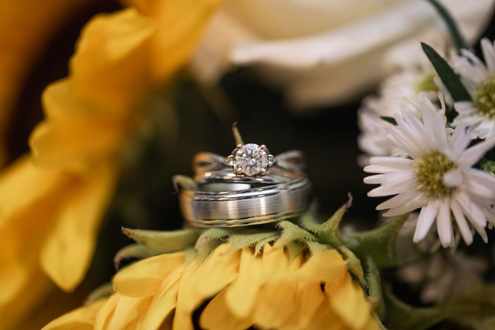 Close up of wedding bands and flowers