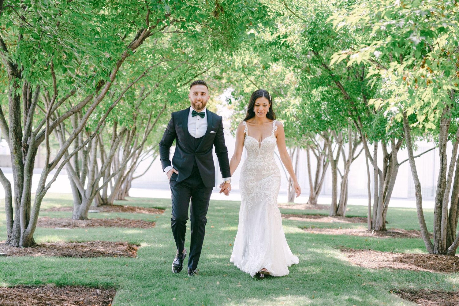 Wedding Couple Holding Hands Under Trees
