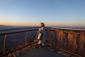 Scenic overlook with protective barriers offering panoramic views of vast canyon landscape.