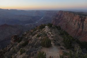Aerial view of the Grand Canyon showing dramatic cliffs and valleys at dusk.